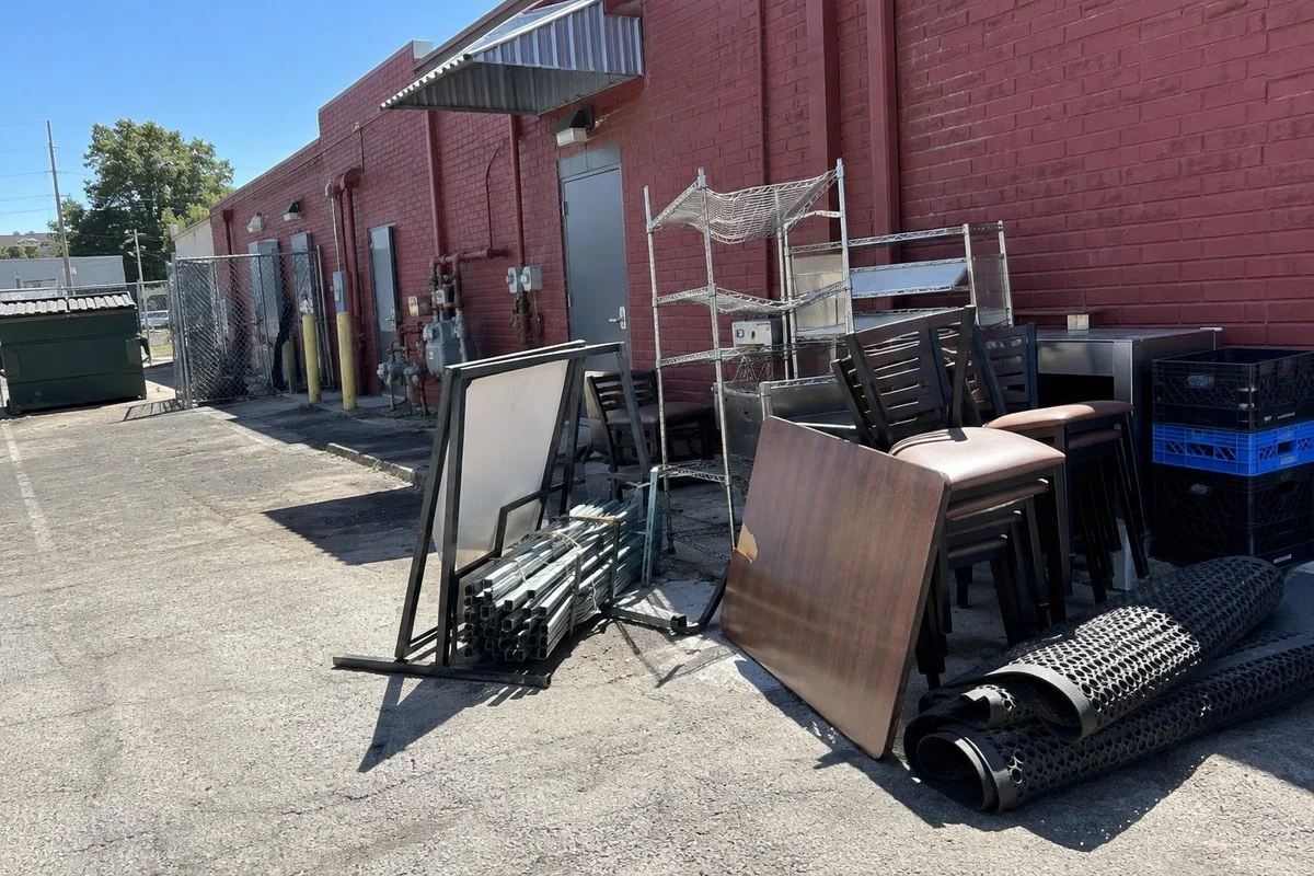 Illegal dumping cleared from a restaurant alley by a commercial debris removal crew