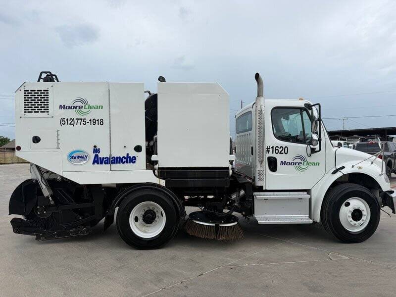 Moore Clean sweeper truck cleaning the footprint after a debris haul-off