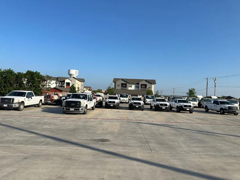 Our office parking lot with multiple power sweeping trucks and maintenance pickup trucks