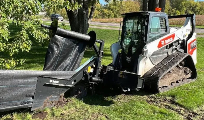 installation of silt sheets for erosion control in action, using a bobcat tractor