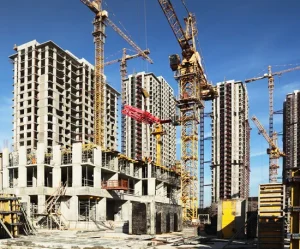 A construction Site with building in progress and equipment including construction cranes